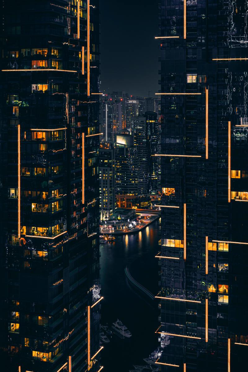 A futuristic city at night with bright yellow lights. 