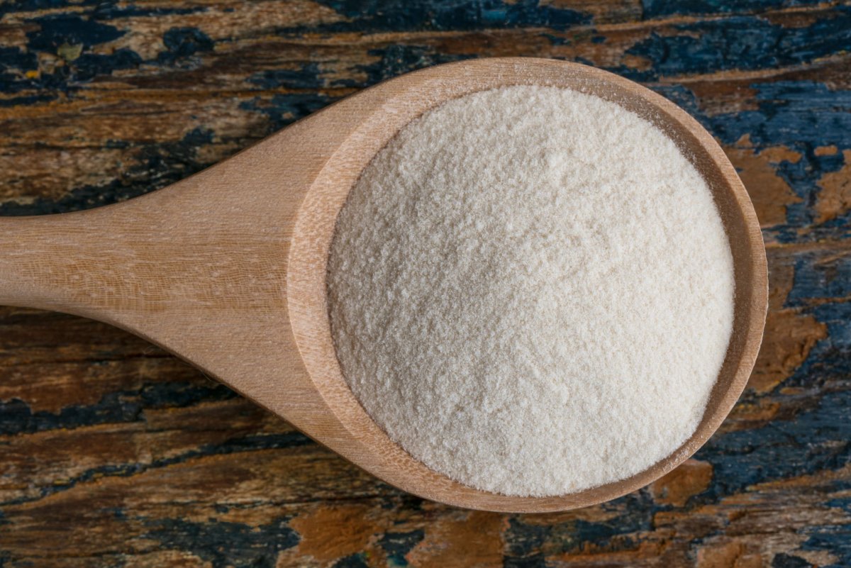 Wooden spoon containing xanthan gum powder.
