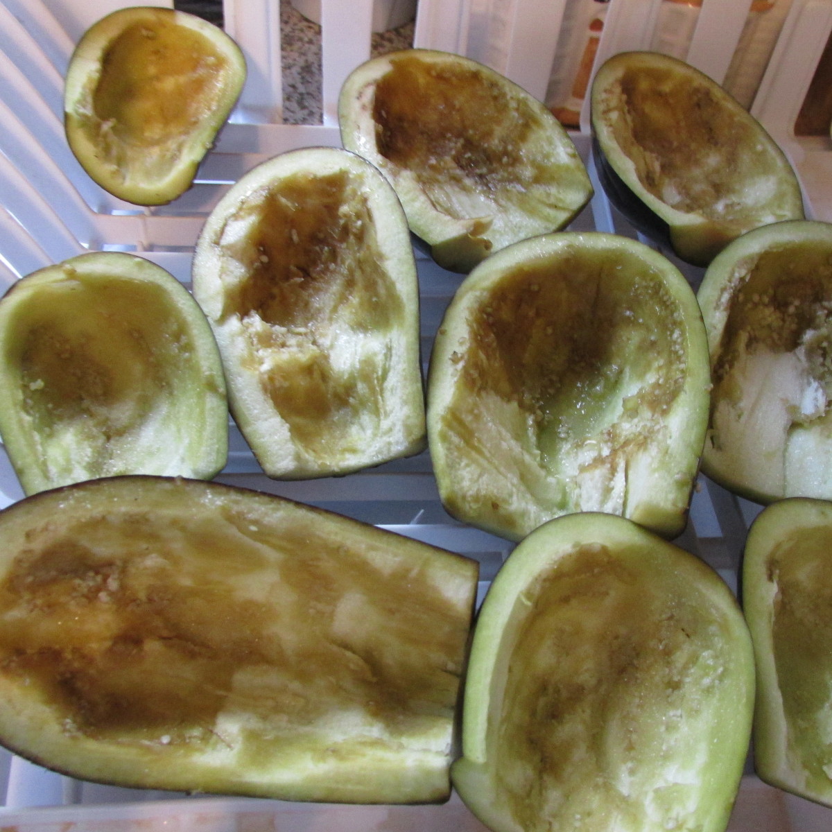 Eggplants after they are scooped out,  salted, and sitting in a drainer