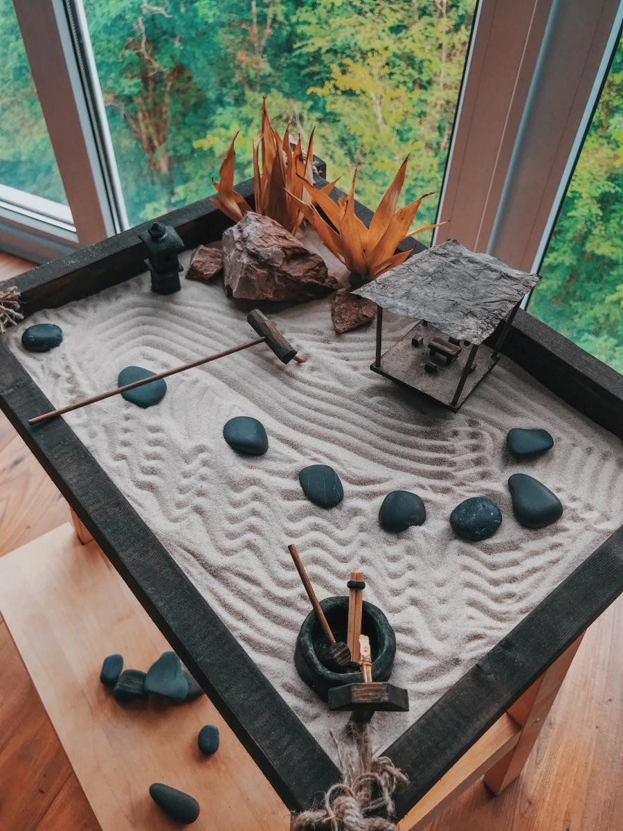 A miniature zen garden where you can arrange stones and rake sand can be comforting. These are low-stress activities.