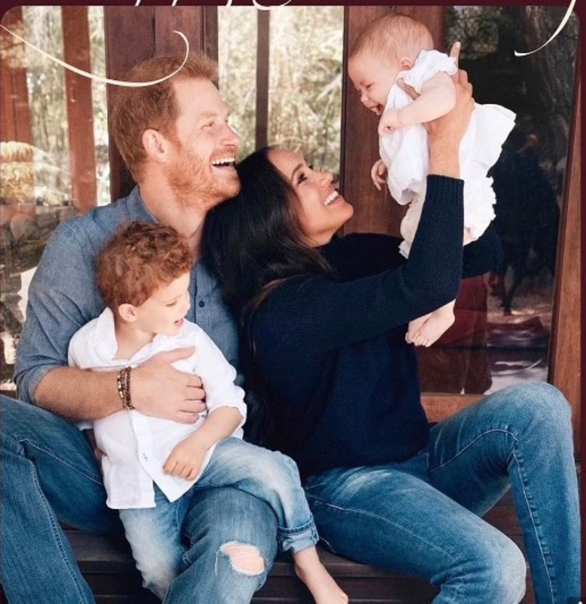 Prince Harry holding Archie and Meghan Markle, Duchess of Sussex, holding Lilibet