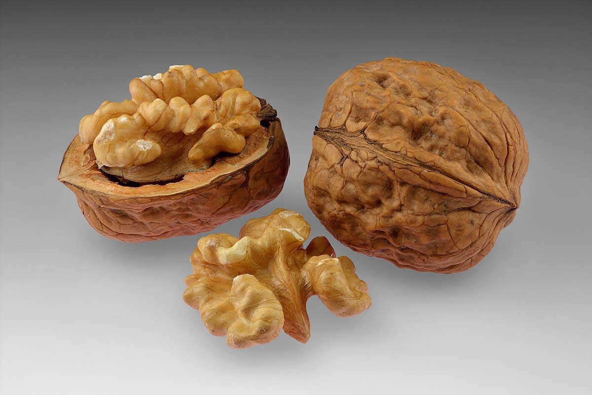 Walnuts; whole and open with halved kernel.