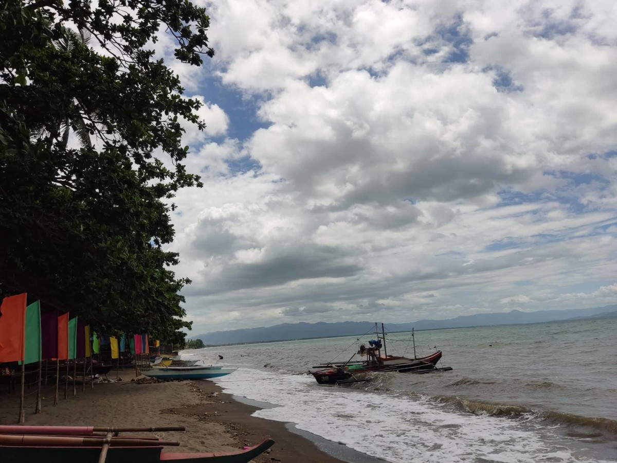 A portion of Amlan's beach showing a few fishing boats. This path up north leads further out to the other coastal barangays.