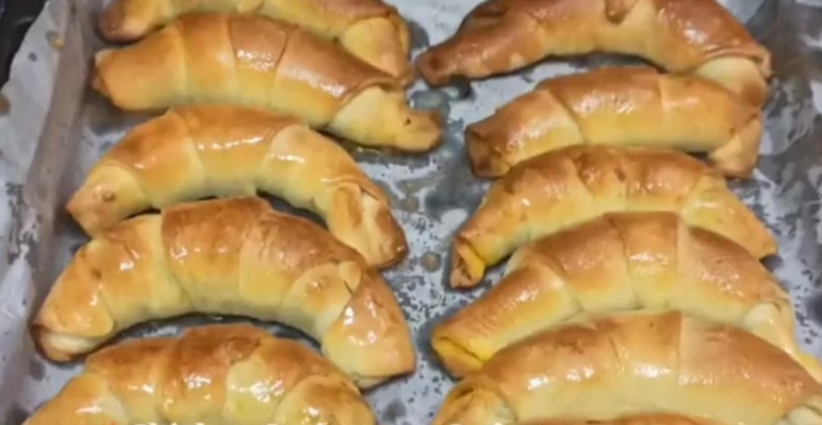 Gently brush the baked croissants with butter before serving.
