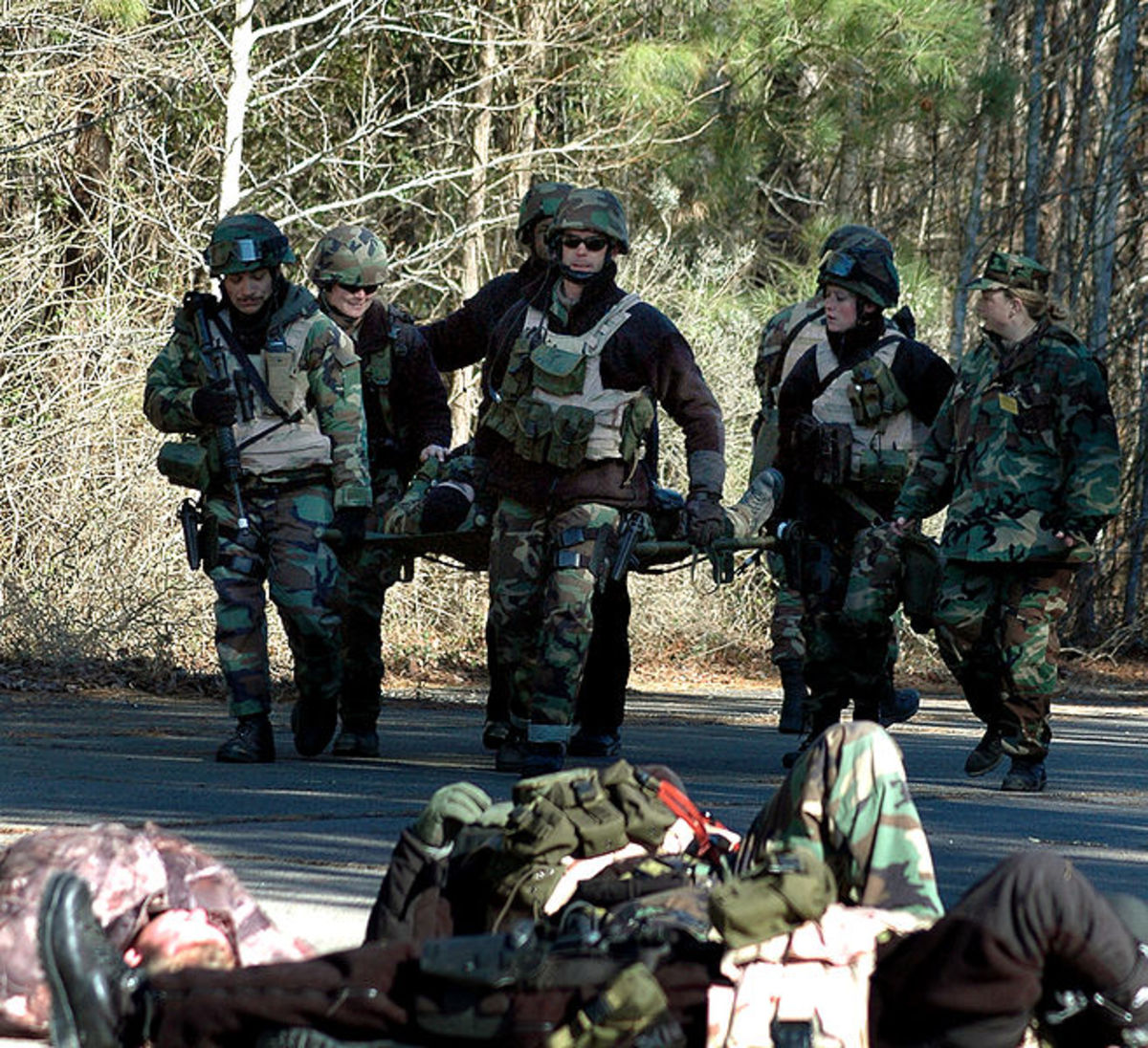 Chesapeake, Va. (Jan. 28, 2005)  Sailors assigned to Mobile Security Squadron Six (MSS-6) carry a wounded comrade during a simulated suicide bomber exercise on board Naval Auxiliary Landing