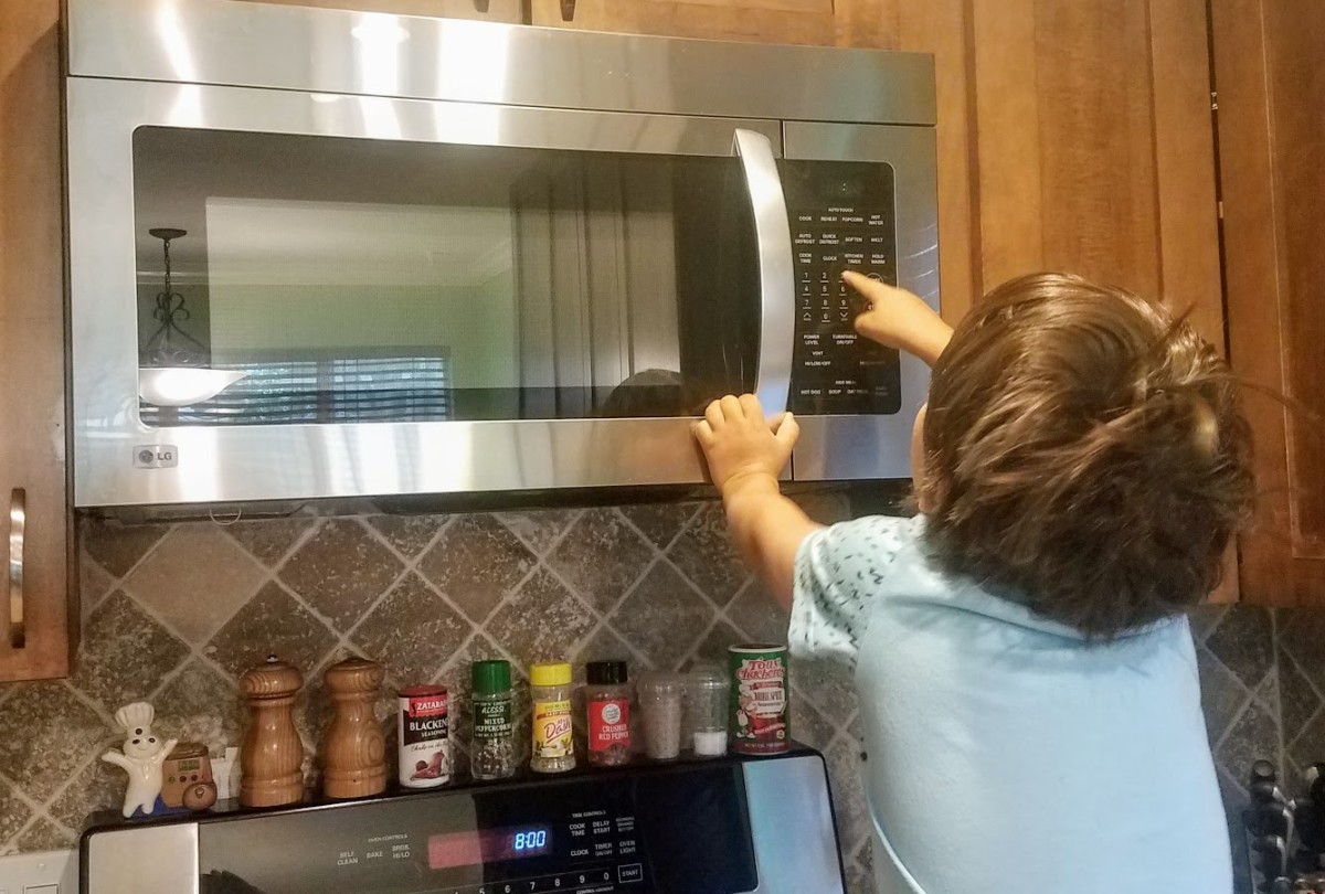 My five-year-old son using the microwave