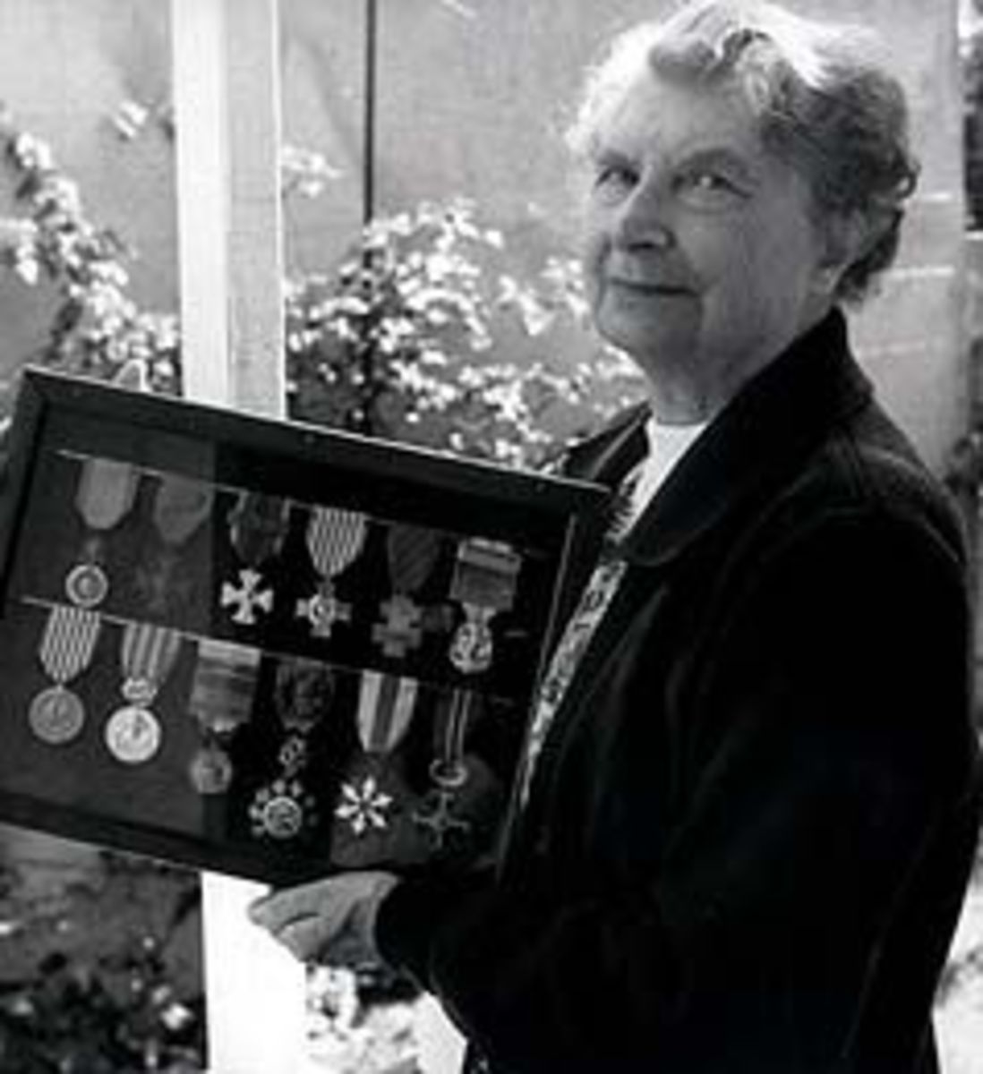 Elderly Susan Travers holding all of her medals