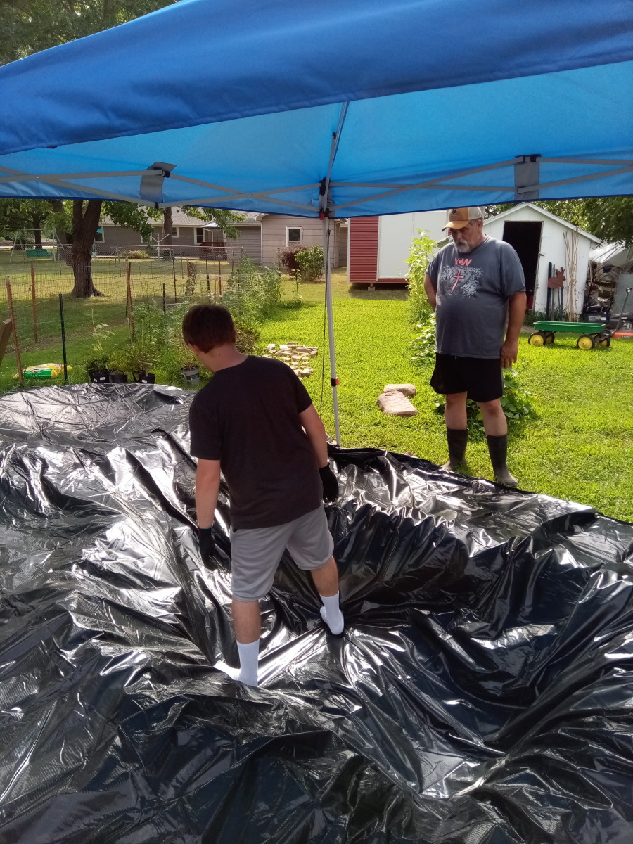 My son spreading out the liner as I supervise