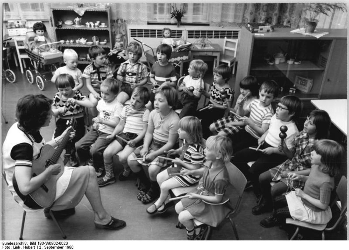 A German kindergarten teacher uses musical instruments to teach the children in her class.