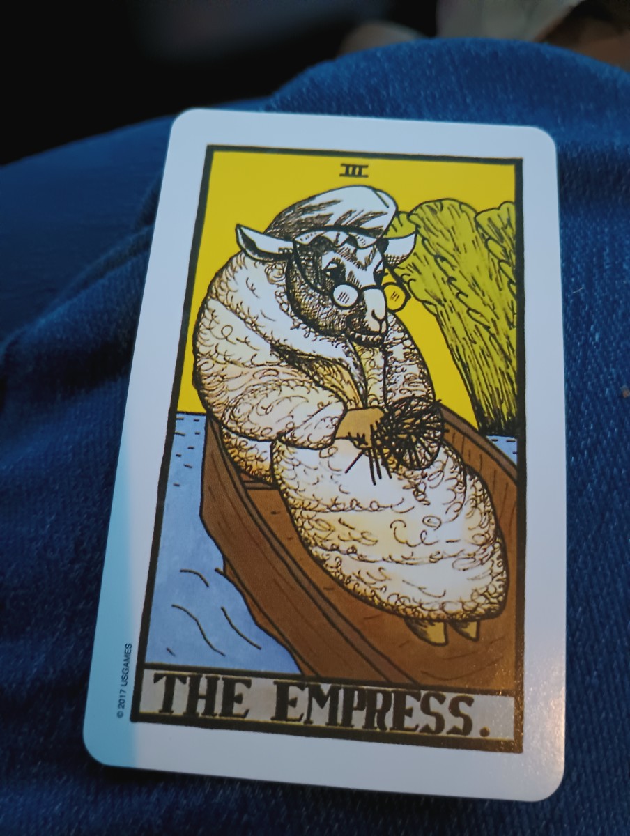 This is one of my favorite decks, especially because of the Empress card, which is depicted as a grandmotherly sheep in the boat most often seen in the 6 of Swords.