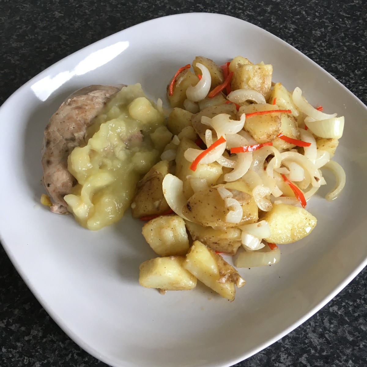 Pan fried pheasant breast with homemade apple sauce and spicy stir fried potato and onion
