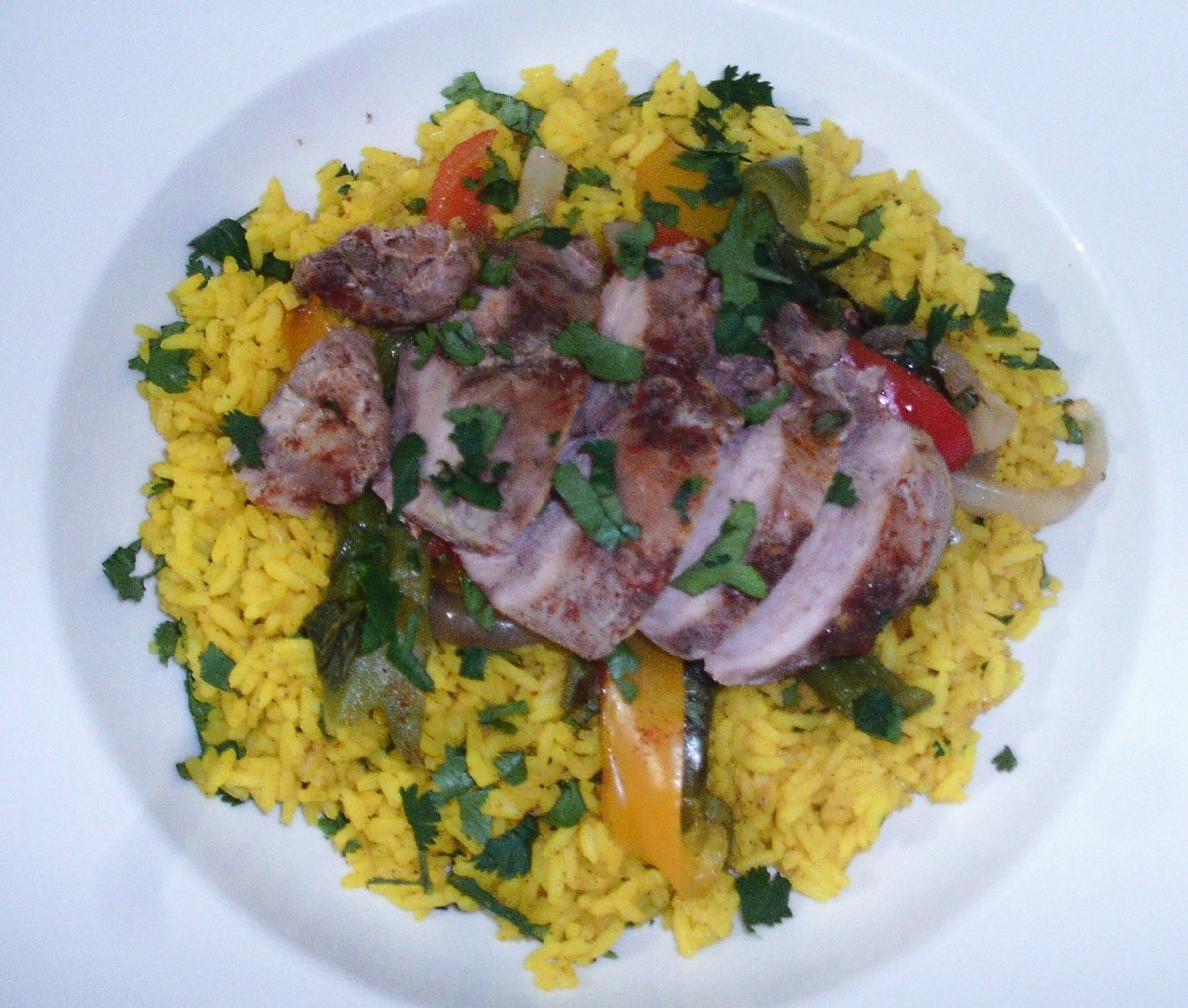 Spicy baked pheasant breast and peppers on turmeric and garlic rice