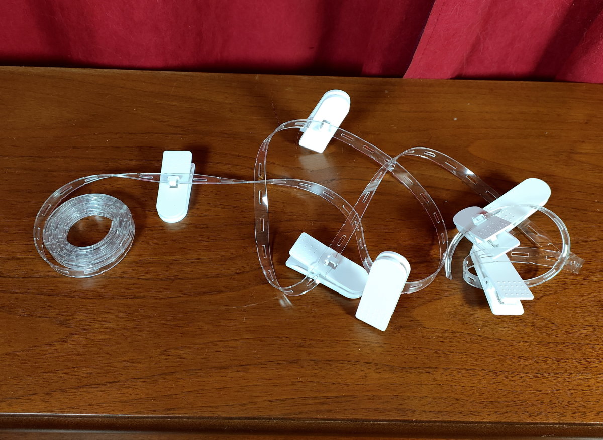 A set of clips arranged for use with grommet-fitted curtains