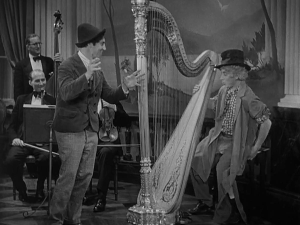 Chico setting up Harpo, who's about to dazzle us with his harp mastery.