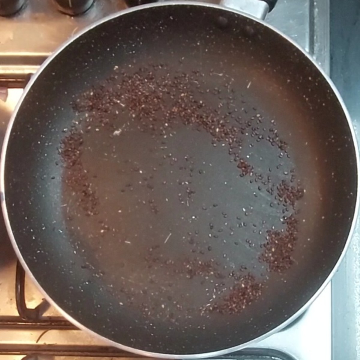 In a frying pan, add 1 tablespoon sesame seeds. Dry-fry till aromatic. Transfer to a plate.