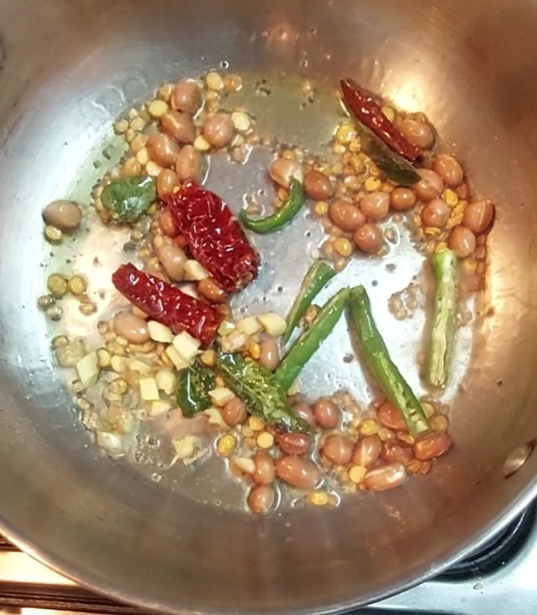 Saute till lentils turn golden brown in color. Do not burn. Add 1 teaspoon chopped ginger and 1-2 green chilies. Saute for a second.