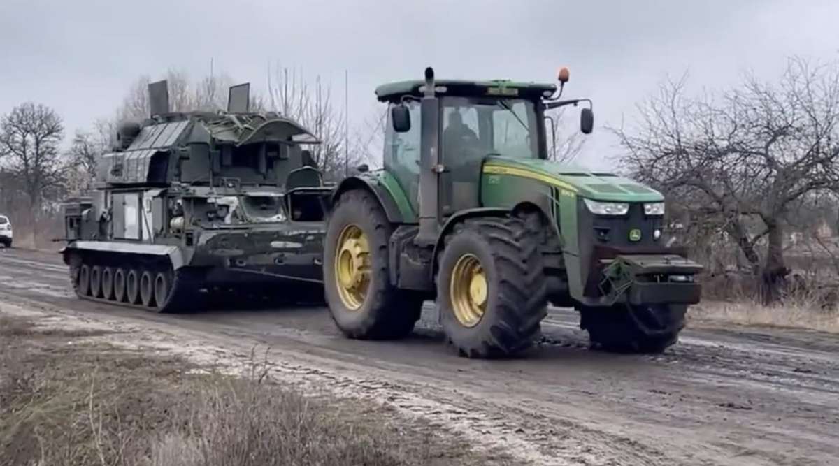 A Ukrainian tractor towing a captured Russian vehicle. 