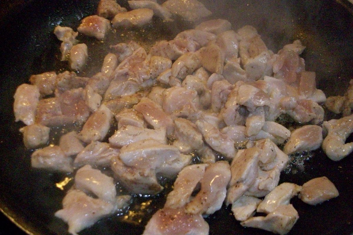 Chicken frying in pan