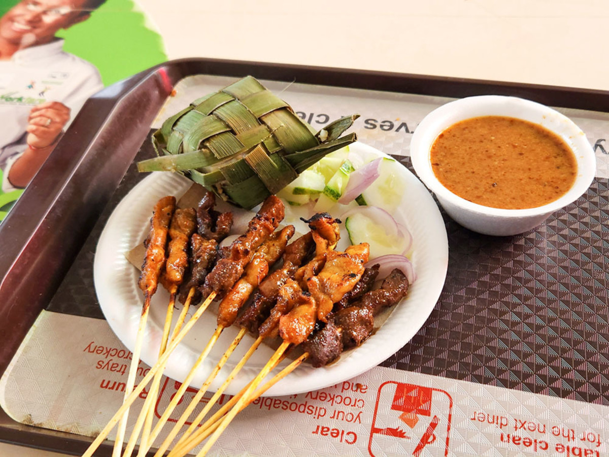 This satay meal, purchased at Newton Food Centre (featured in Crazy Rich Asians), cost SGD 9/-. Each skewer costs SGD 0.50. The Malay-style rice cake is one dollar.