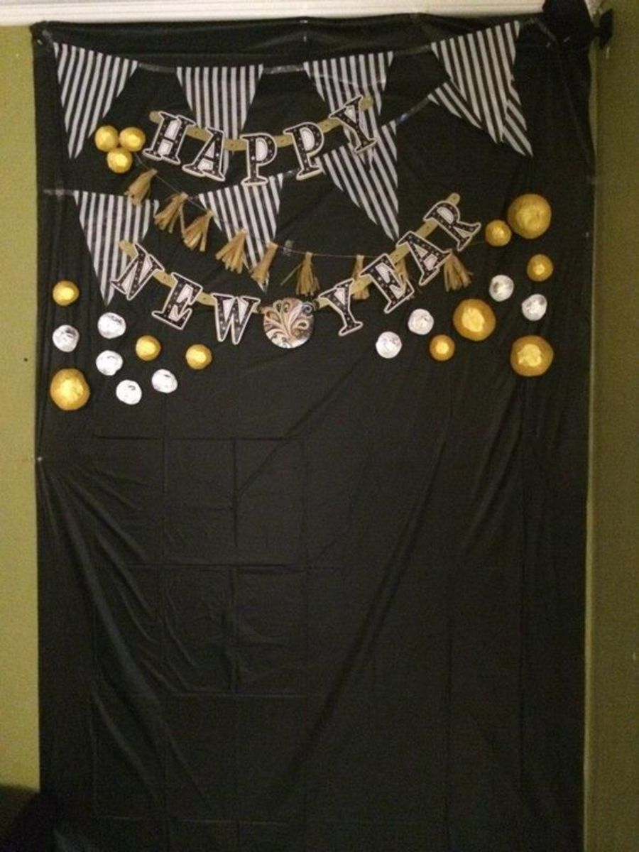 dollar store decorations for the photo backdrop. use cup cake liners for the dots and make the tassel garland out of tissue paper