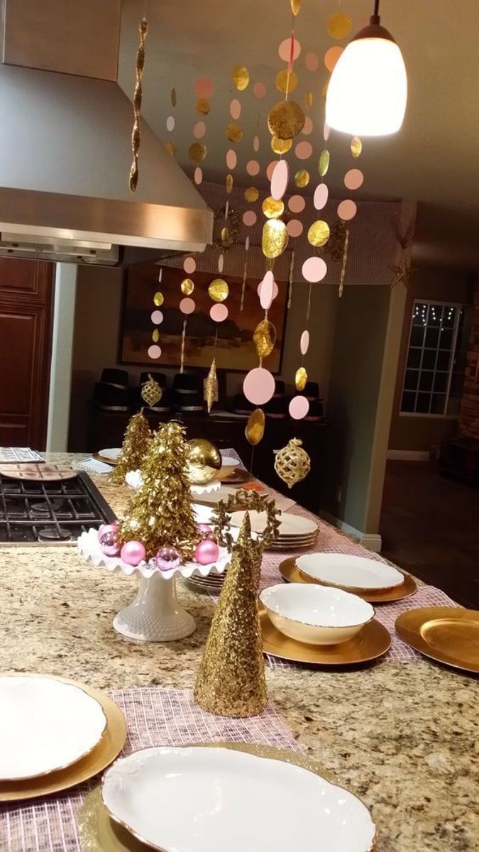 Light Pink and Gold decor for New Years Eve - Make the circles with a hole punch, and ornament on the end, & string with fishing wire most of Gold decor  from Dollar Tree or 99cent store!