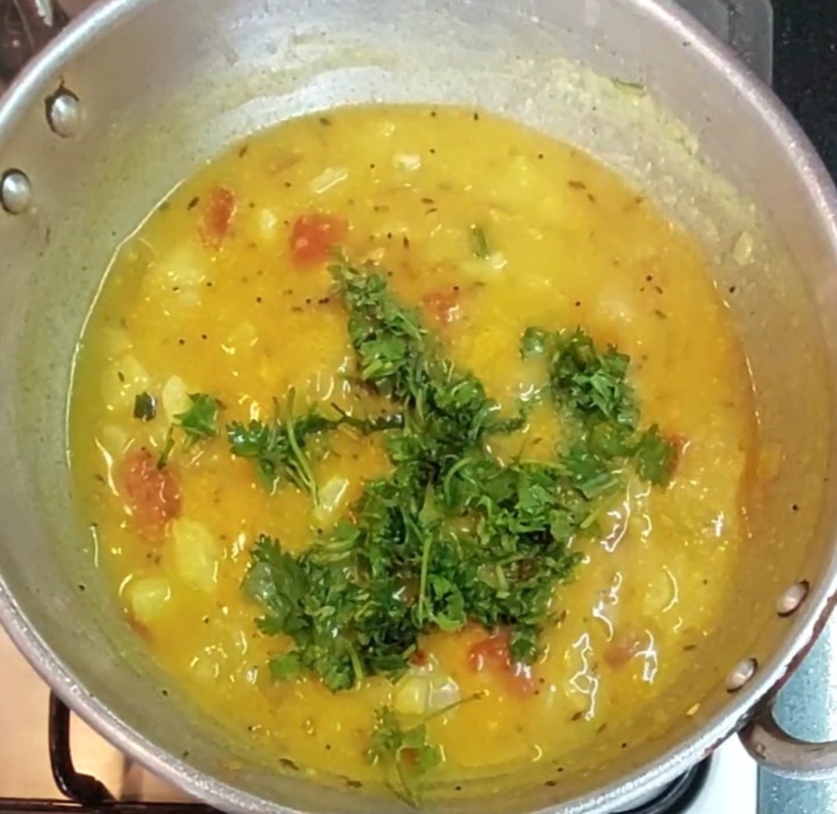 Add water as required to adjsut the consistency. Add 1/2 cup chopped coriander leaves. Mix well and turn of the heat. 