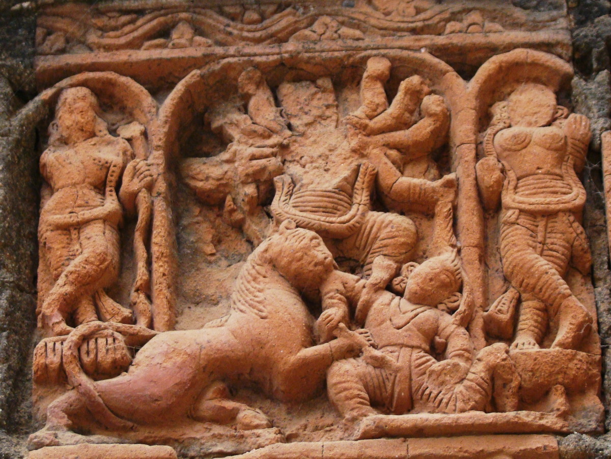 Goiddess Durga slaying the demon Mahishasura. Goddess Laksmi (considered here as the daughter of Durga) is standing on Durga's right. Terracotta; Shiva temple, Supur, district Birbhum