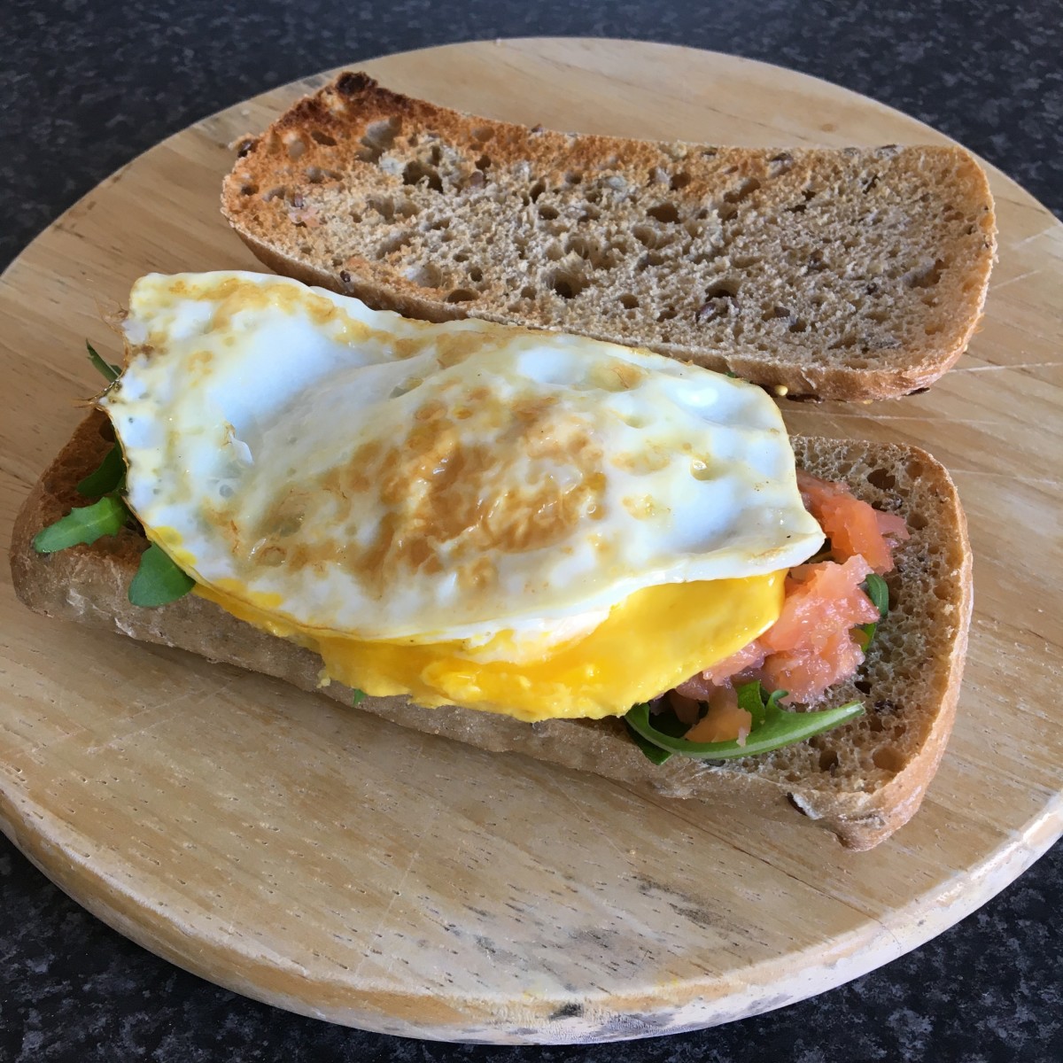 Fried duck egg with smoked salmon and rocket toasted ciabatta sandwich