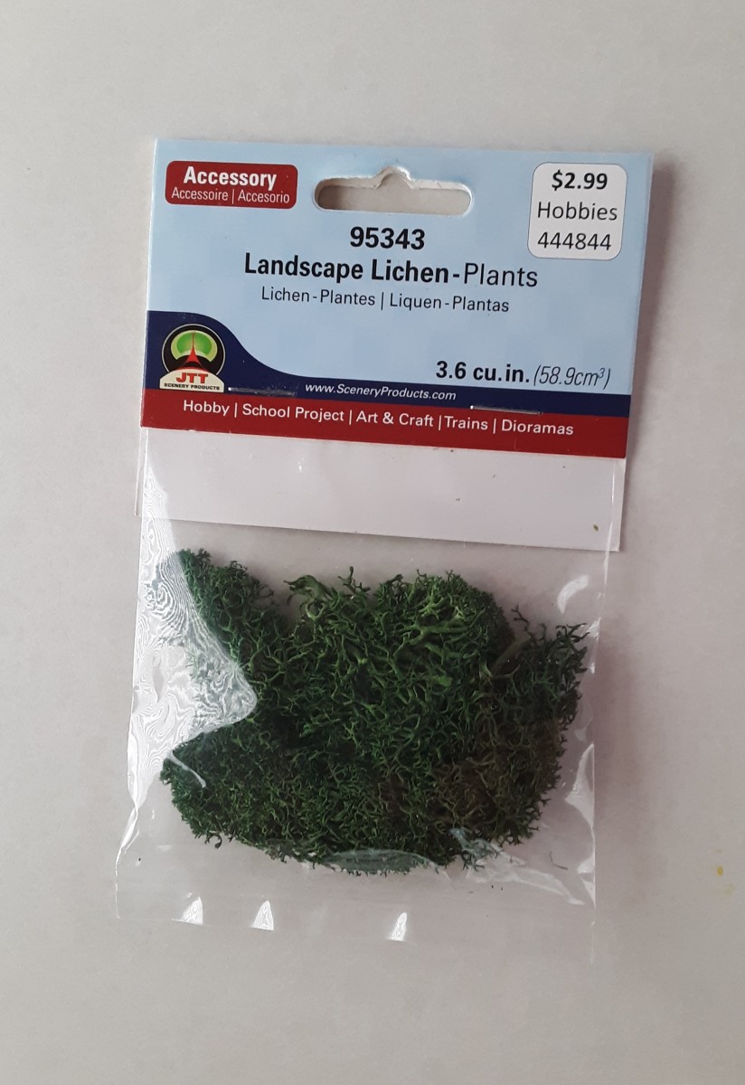 Miniature fake moss! You may find at any crafts store.