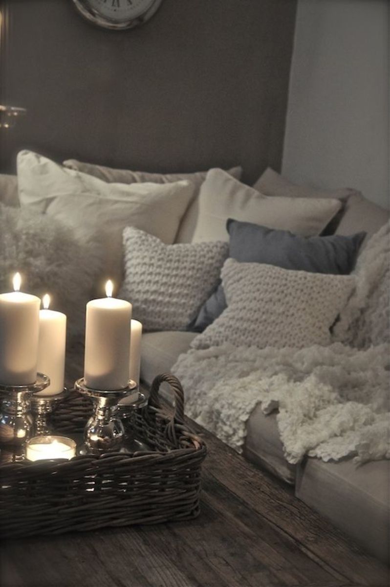 Cozy sofa with blankets, candles & blankets