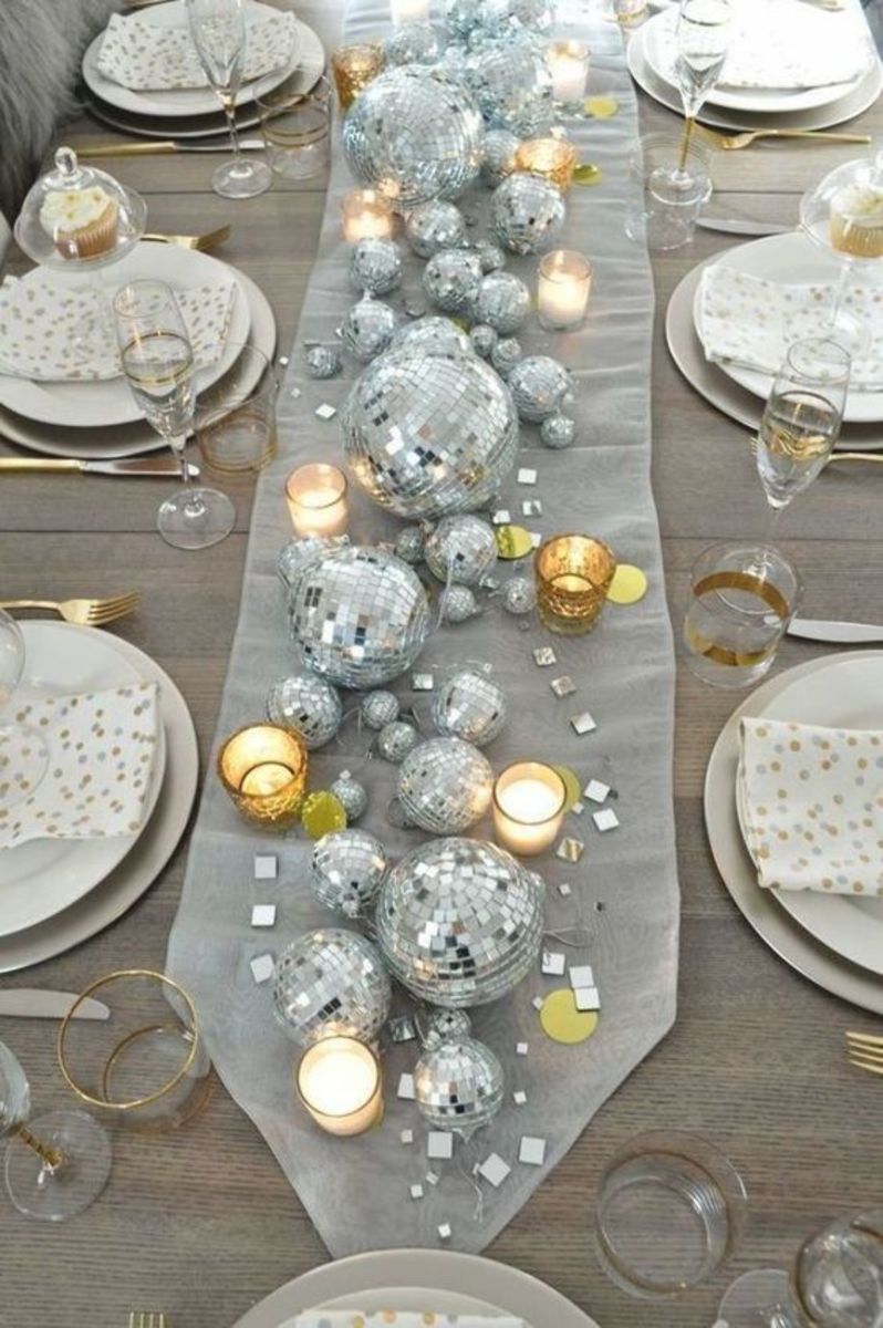 New Year's Eve Table: Be inspired by a disco ball center piece, candles, and a collection of clocks. This elegant table is full of wow factor!