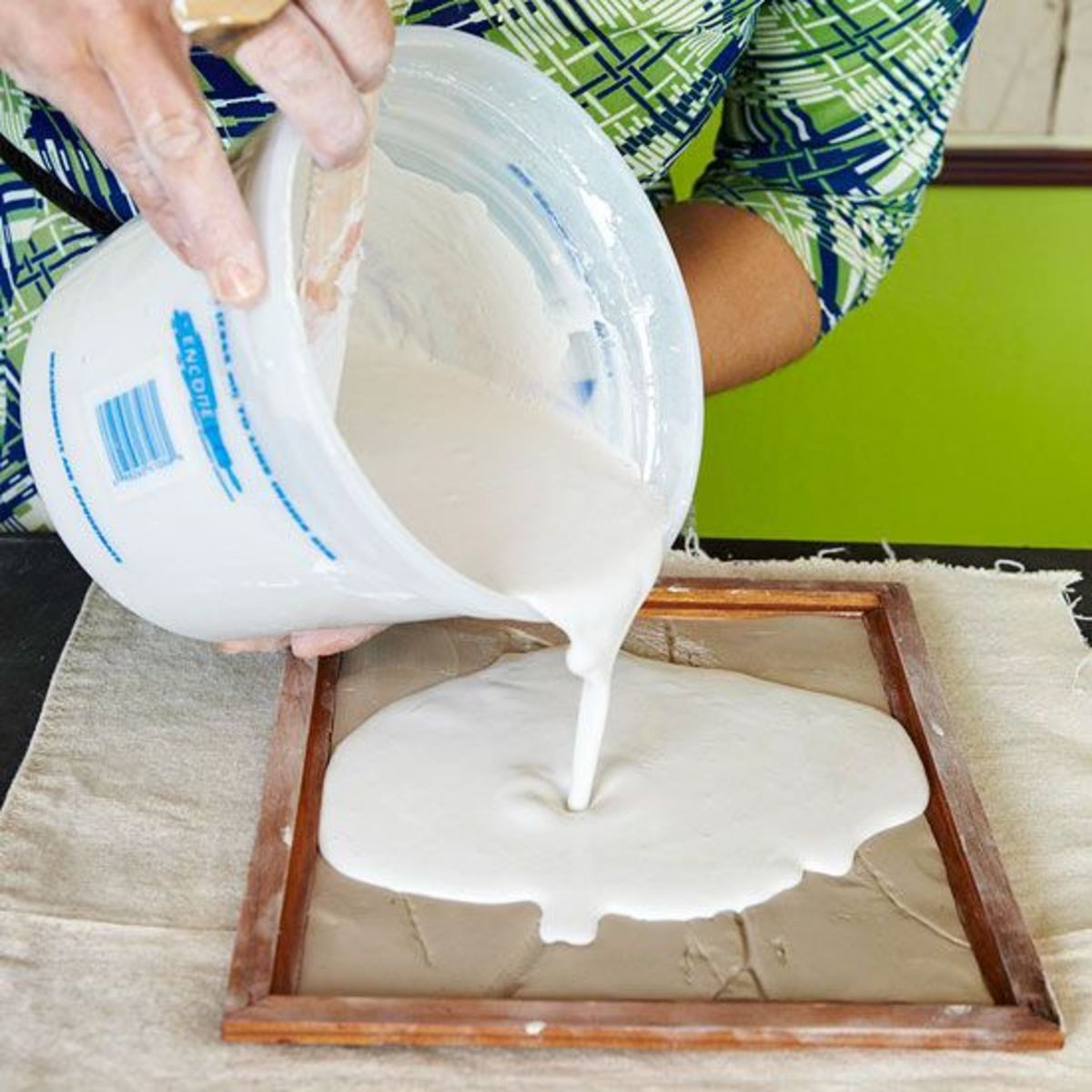 Pouring the mixed plaster of Paris into the mold