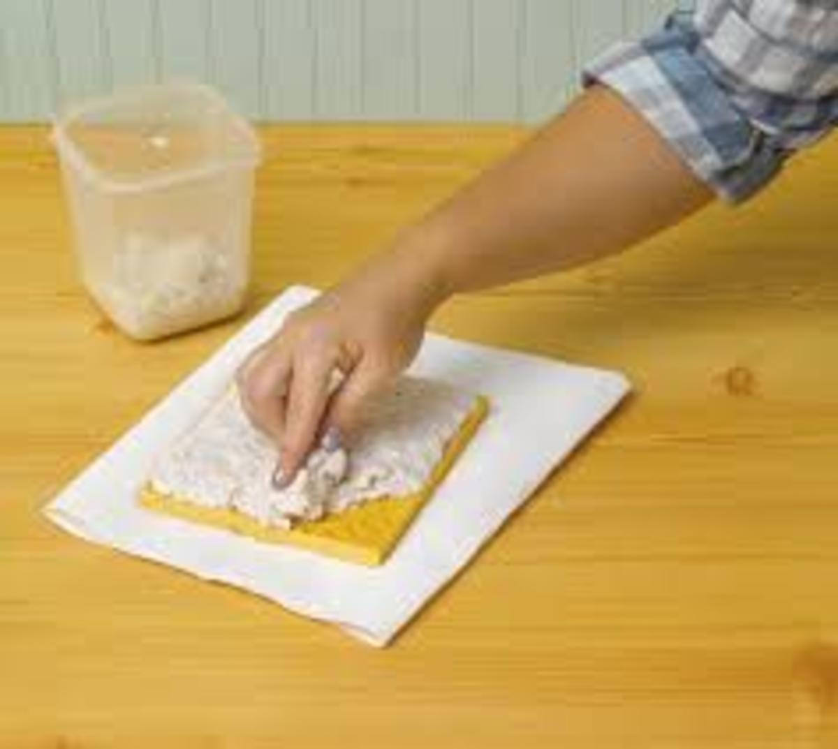 Press the pulp into the carved linoleum block.  Place a piece of screen on top of the pulp and use a sponge to remove the excess water.  Add more pulp and repeat the steps until the thickness is achieved.  Gentle remove from the mold.