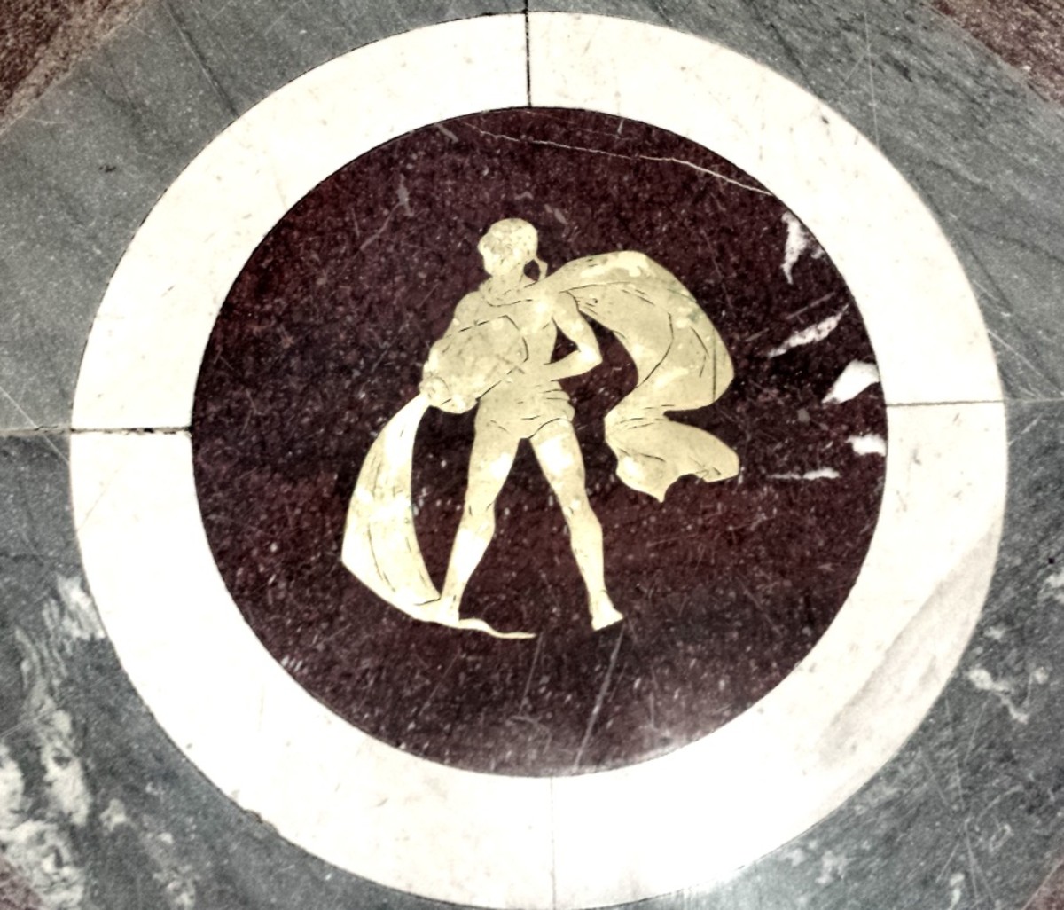 Aquarius, pouring out knowledge for all humanity. All 12 signs of the zodiac are inlaid, in brass, in the marble floor of the Library of Congress, Washington, D.C.