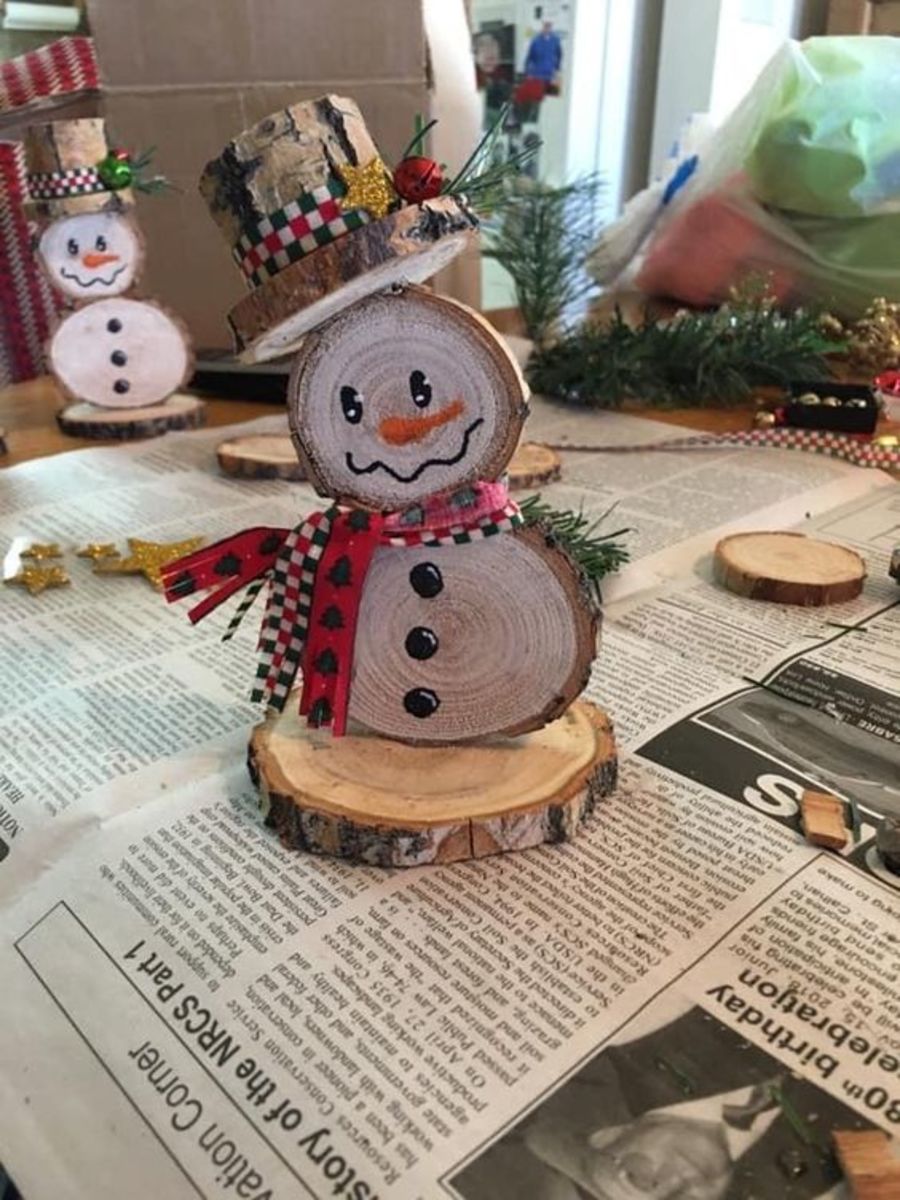 Make cute centerpieces out of wood slices decorated like snowmen.
