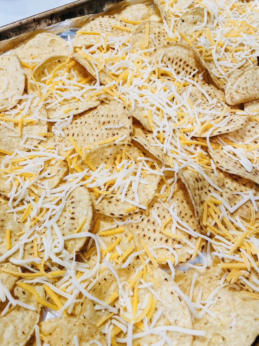 Sprinkle the cheese on top of the tortilla chips.