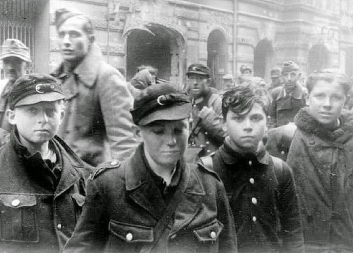 Child soldiers caught during the Battle of Berlin, April-May 1945. Most of them were ordered to ditch the uniform and go home. Behind them appears to be a column of their elders headed toward a processing center.