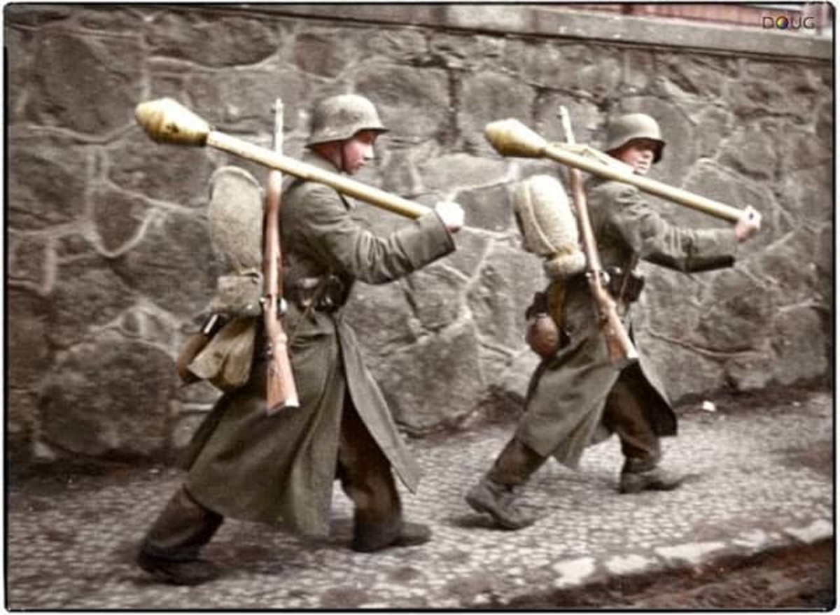 Two young German soldiers armed with Panzerfausts and Mauser rifles, march along Bankowa street in Lubań (Lauban), Lower Silesia, 1945. This was the site of one of the last successful German operations of WW2