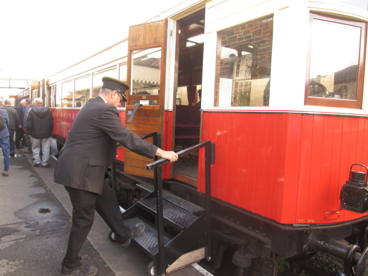 At Embsay on the line from Bolton Abbey late September, 2022, the conductor sets the steps again the railmotor body