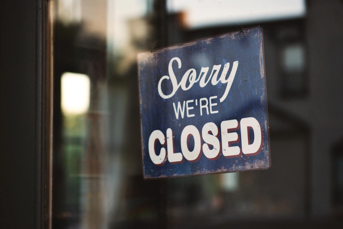A 'Closed' sign hangs from a glass window. Your favorite places, which may include convenience stores, have their own time and place. It's important to appreciate them while you can.