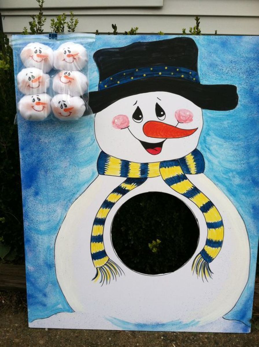 Snowball Toss Game. Snowman made from foam core board. Snowballs made with fleece and painted faces