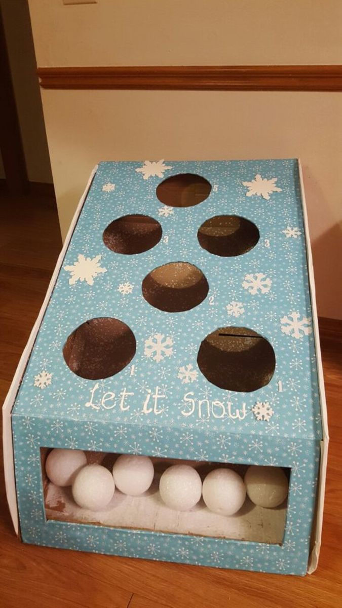 Throwing snowballs 1 cardboard box, Wrapping paper, styrofoam balls, Glue gun.