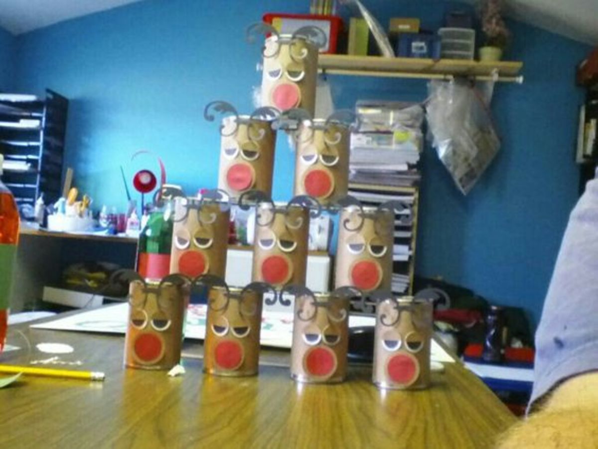 Make these out of empty cans then stack and knock down for Christmas carnival game