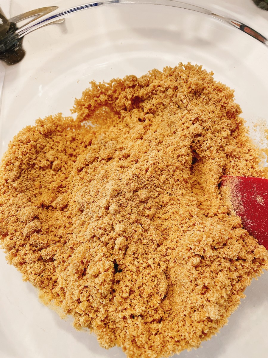 In a large bowl, combine the crushed crackers with melted butter, and mix well to combine.