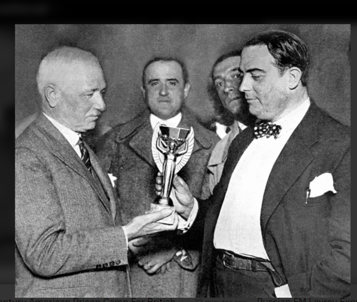 Jules Rimet, president of FIFA, presenting the Jules Rimet trophy to Dr. Raul Jude, president of the Uruguayan football association. The trophy would be presented at the 1930 World Cup finals in Montevideo.
