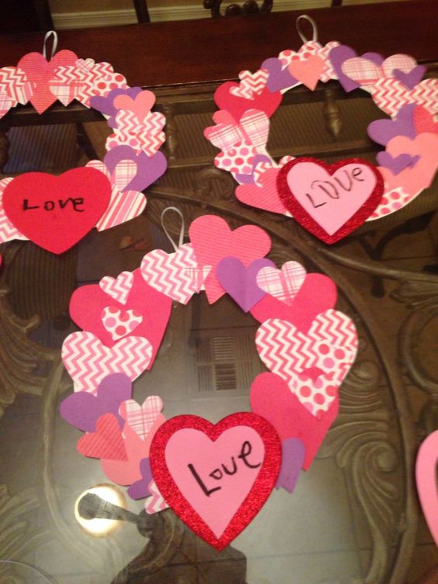 Valentines Day Wreath Craft. Use scrap paper, thick paper for the backing and dollar store foam hearts for the bottom heart and have the kiddos write LOVE.