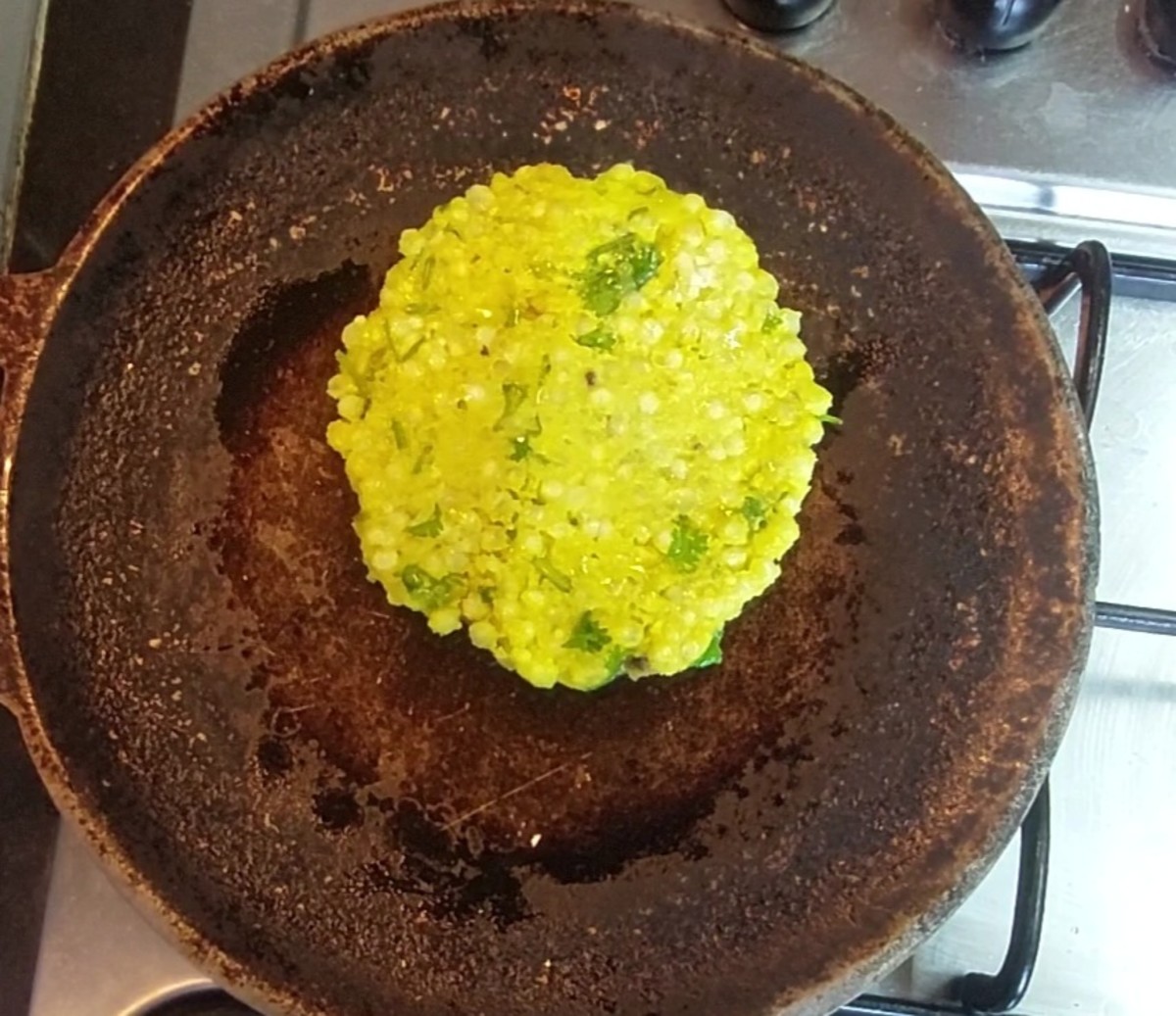 Heat a tawa on medium flame. Drizzle a few drops of ghee over the tawa, drop roti on the tawa and lift butter paper gently to remove it. Cook for a minute.