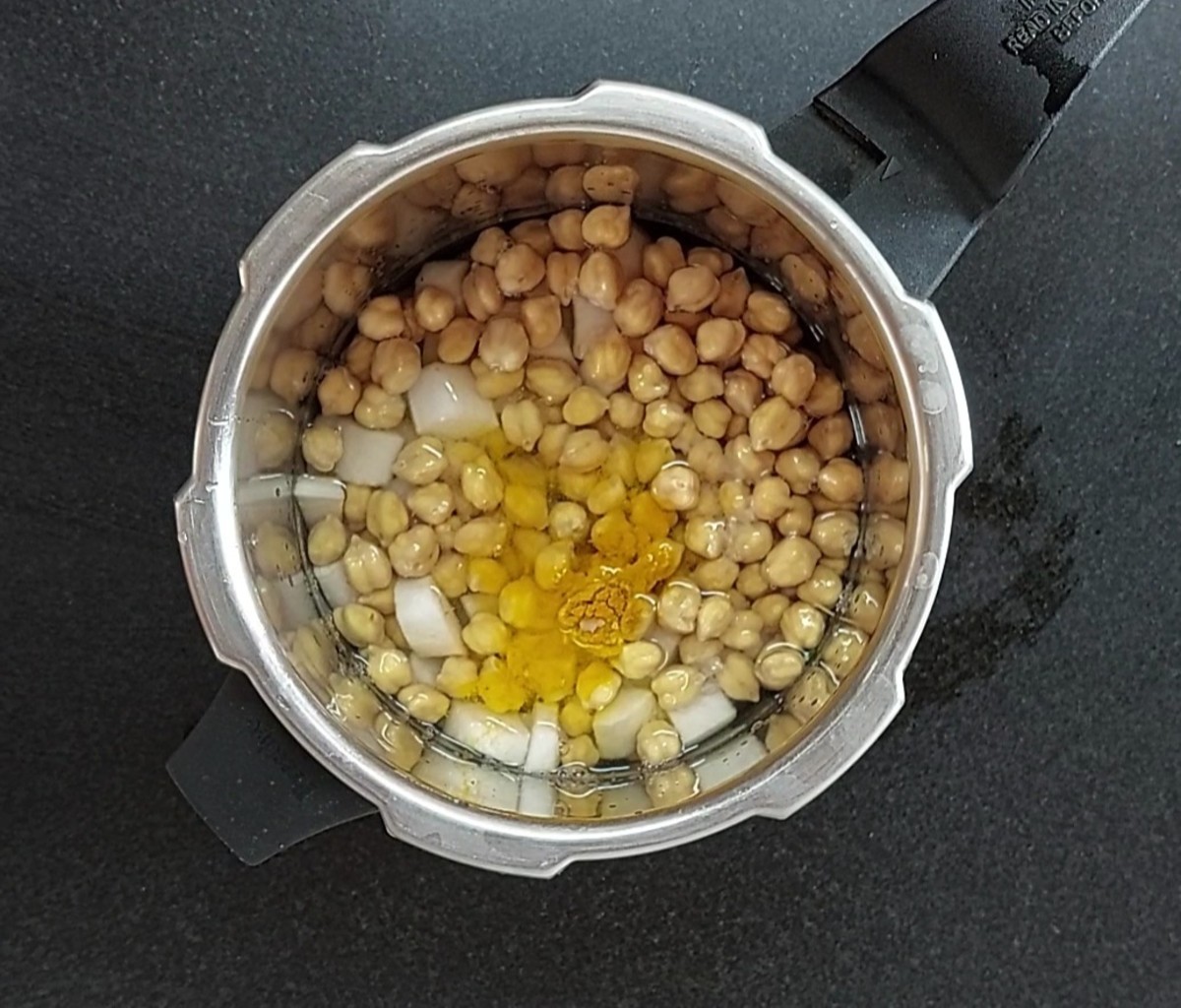Drain water from 1 cup of soaked chana (soaked overnight), transfer to the cooker, add 1/2 teaspoon turmeric powder, salt to taste and 2 cups of water. Close the lid and take 3 whistles. Let the pressure subside naturally.