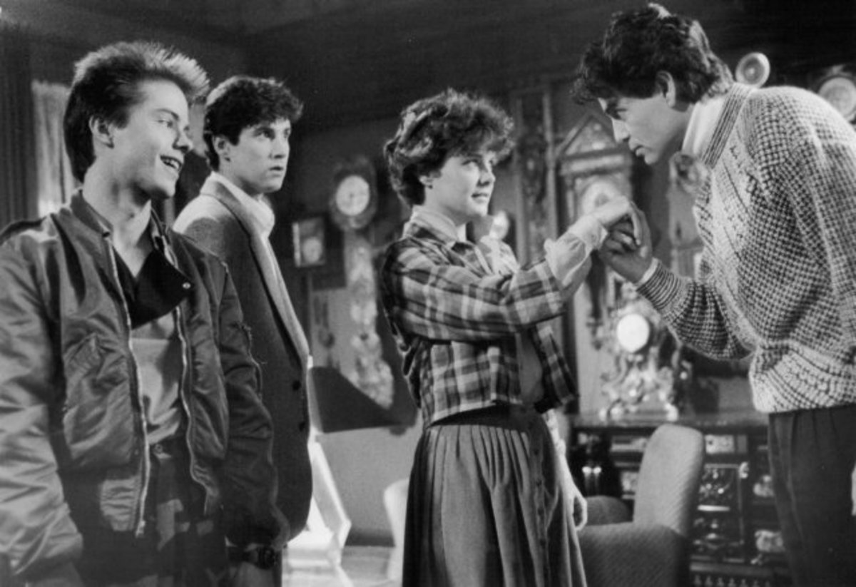 Chris Sarandon charms Amanda Bearse in Fright Night as Stephen Geoffreys and William Ragsdale look on