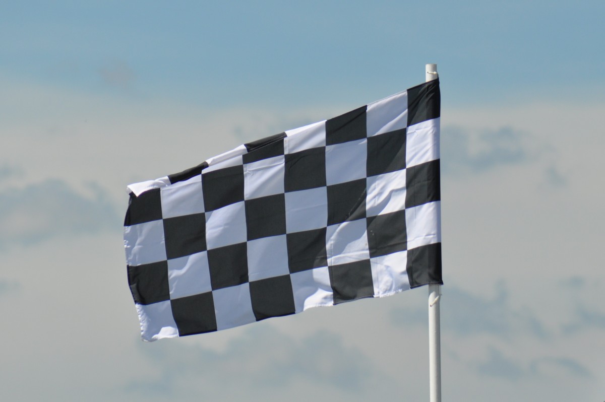 Chequered flag signals the end of a race.